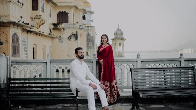 Romantic Indian Couple in Traditional Ethnic Wear Standing Near Historic Architecture
