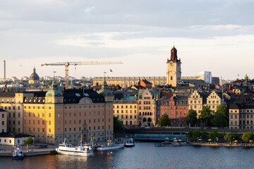 Obraz premium Stockholm Old Town waterfront and skyline illuminated by warm evening light, Sweden