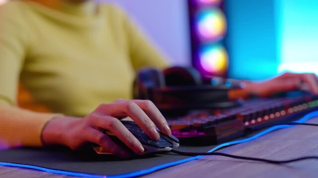 Woman using gaming computer setup with RGB lighting, playing online video games at home, featuring esports, streaming, technology, entertainment, and modern gamer lifestyle.