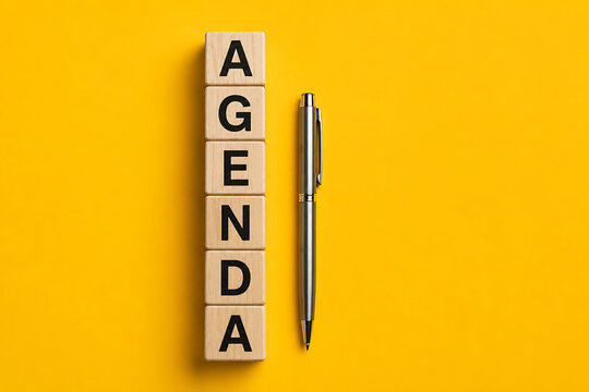 Agenda planning concept with wooden alphabet blocks and pen representing organized scheduling productivity and effective business management practices today