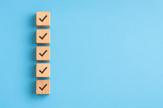 Checklist completion concept with wooden checkmark blocks representing task organization productivity verification and efficient workflow management solutions today