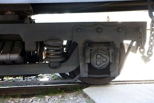 mechanical side profile of a train car bogie assembly, steel wheels, and suspension springs 