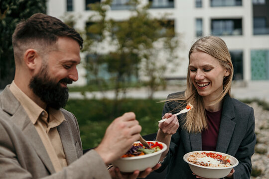 Business colleagues enjoying healthy lunch outdoors during break