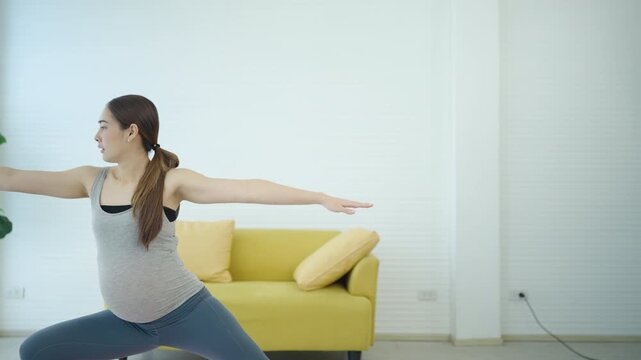 Pregnant woman practicing yoga stretching exercise at home, promoting prenatal fitness, wellness, flexibility, healthy pregnancy, relaxation, and mindful healthy lifestyle.