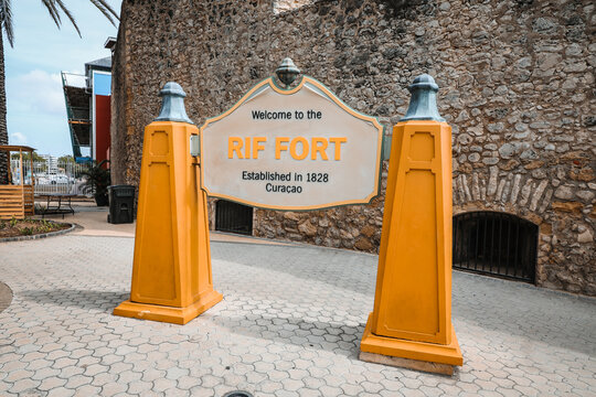 Welcome sign at the historical Rif Fort entrance, a 1828 colonial fortress converted into a shopping and dining courtyard in Willemstad, Curacao.