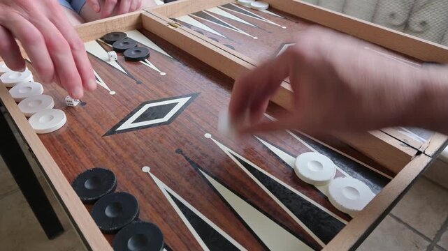 players rolling the dice and playing backgammon