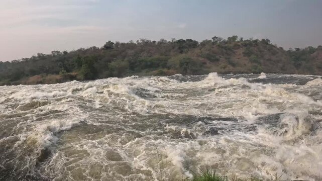 Cinematic footage of Murchison Falls Uganda with powerful Nile River crashing through dramatic gorge, epic travel video