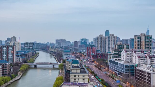 Nanjing China city skyline with river and bridge at evening