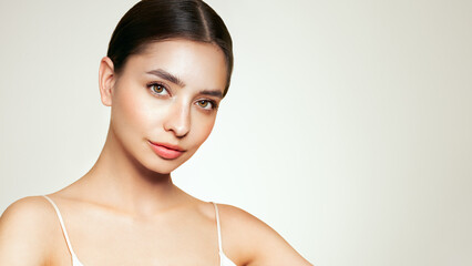 Fototapeta premium Portrait beautiful young woman with clean fresh skin. Model with healthy skin, close up portrait. Cosmetology, beauty and spa