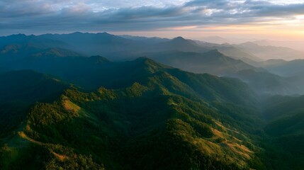 Naklejka premium A breathtaking aerial view of majestic mountain ranges bathed in the warm golden light of the golden hour