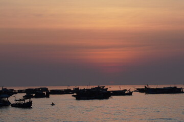 Dramatic Golden Sunset Over Silhouette of Floating Fishing Village © Hung