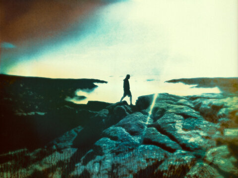 man walking above clouds