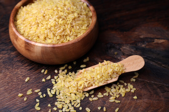 bulgur wheat grains in wooden spoon