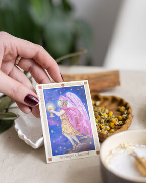 person holding a holy card of the archangel Chamuel