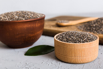 Chia seeds in bowl and spoon on colored background. Healthy Salvia hispanica in small bowl. Healthy...