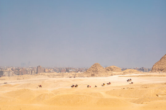 The Giza Pyramids in Cairo, Egypt, panoramic view. General view of the pyramids from the Giza plateau. Three pyramids, known as the Queen's Pyramids, are on the front.