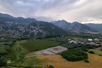 Naklejka premium Historic Seljuk caravanserai of Kırkgöz Han surrounded by the Taurus Mountains near Antalya, Türkiye.