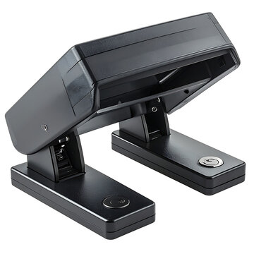 Black office hole puncher on a white surface, office supply, stationery equipment, tool for binding documents