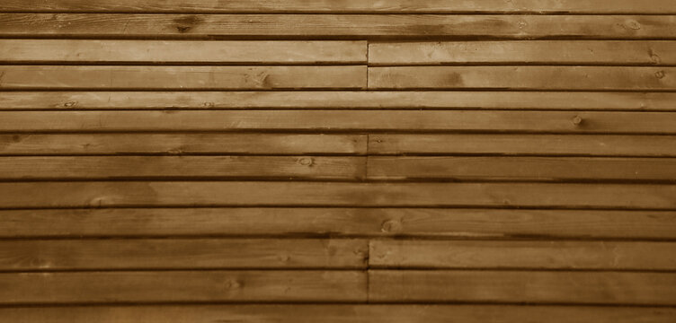 vertical dark brown wooden slats texture for interior decoration with light from above. walnut wood slats in vertical striped line pattern used as background or backdrop.