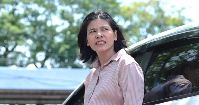 Stressed woman beside a car outdoors, Businesswoman missed career goals, representing frustration, unemployment, anger, pressure, waiting and failure, Thai Asian woman