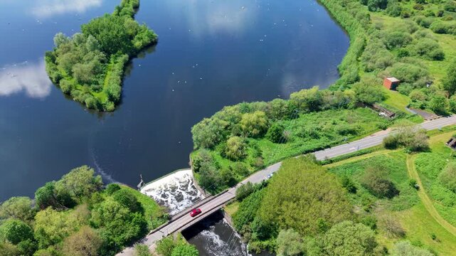 Aerial view of a large concrete weir regulating water flow on the River Tame near Kingsbury