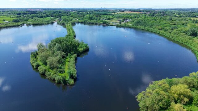 Aerial view of a large concrete weir regulating water flow on the River Tame near Kingsbury