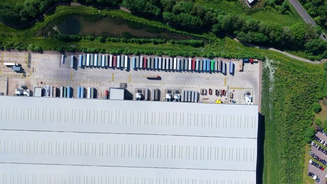 Top Down Aerial Drone Shot of Large Industrial Distribution Centres and Factories with Rows of Heavy Goods Vehicle HGV Trailers in Hinckley UK