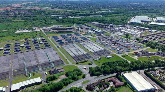Birds eye view of a large municipal wastewater processing facility with circular sediment tanks