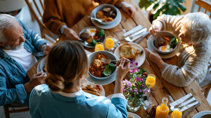 Fototapeta premium A European nurse viewed from above in soft blue uniform serves a bright breakfast to calm elderly residents at a sunny nursing home table in soft daylight nursing breakfast