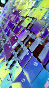 Iridescent sequin wall shimmering with colorful reflections, abstract luxury event backdrop and festive decorative texture