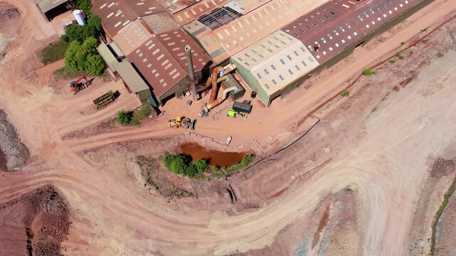 Aerial view of heavy plant machinery, earthmoving equipment, and industrial chimney stacks at a brick manufacturing facility in Tamworth, Staffordshire, UK.