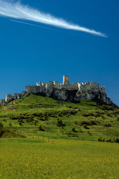 Wide panoramic view of Spis Castle on a green hilltop