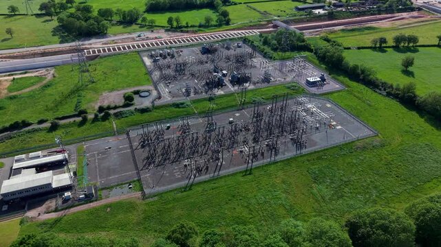 High angle aerial drone view of a massive high voltage electrical substation for bulk power distribution and grid resilience near Berkswell West Midlands UK