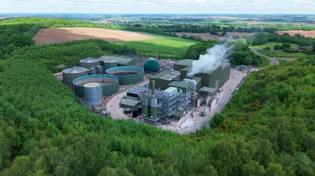 High angle aerial drone view of a large anaerobic digestion facility producing biogas and renewable electricity for the national grid near Atherstone Warwickshire UK