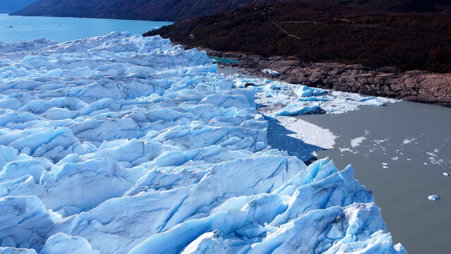 Los Glaciares National Park In El Calafate Santa Cruz Argentina. Aerial View Of Massive Glacier Calves Into A Lagoon Of Icy Water. South Pole Tourism Iceland Snow Mountain.