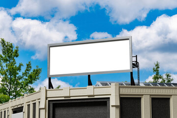 Fototapeta premium Outdoor advertising billboard template with empty white screen against blue sky 