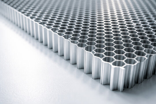 Close-up view of aluminum honeycomb panel structure on white surface