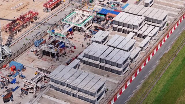 Drone shot of thousands of concrete railway components stockpiled at an industrial infrastructure factory yard near Birmingham