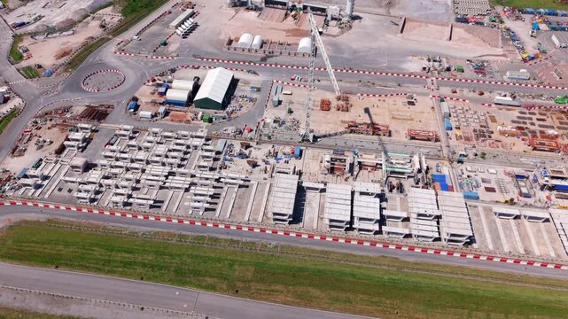 Drone shot of thousands of concrete railway components stockpiled at an industrial infrastructure factory yard near Birmingham