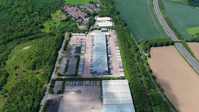 Aerial View of a Long Industrial Factory Hub and Logistics Depot with Rows of HGV Trucks and Trailers Lined Up for Freight Transport in Kingsbury UK