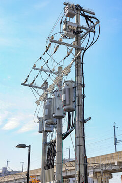 AC high-voltage power transformer, Electrical Transformer and High voltage power lines installed on electric pole.