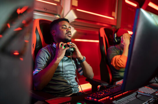 Focused gamers competing in esports arena