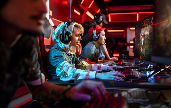 Esports team competing in pc game at neon gaming arena