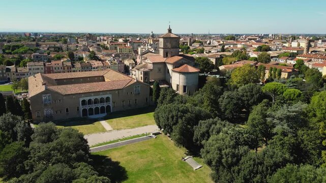 Aerial drone footage of Basilica di Santa Maria in Porto with surrounding greenery and cityscape in Ravenna, Emilia-Romagna, Italy.