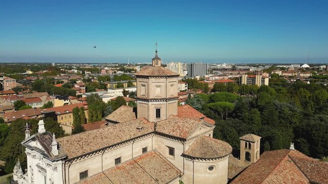Drone view of Basilica di Santa Maria in Porto and surrounding rooftops in Ravenna, Emilia-Romagna, Italy, on a sunny day.