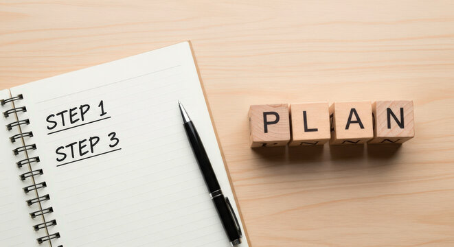 Planning and organization with notebook and pen steps wooden blocks
