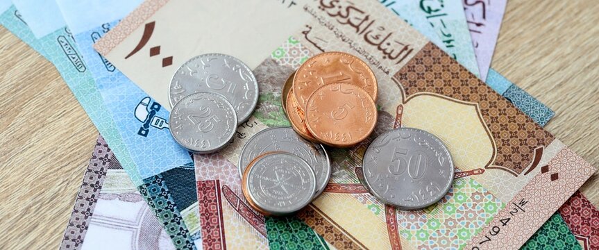 Omani rial money bills and coins on table. Oman cash of OMR currency close up