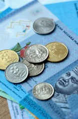Malaysian ringgit money bills and coins on table. Malaysia cash of MYR currency close up © Larysa