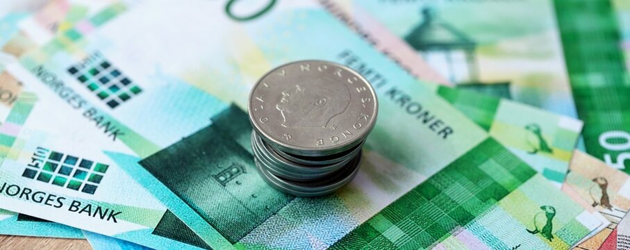 Norwegian krone money bills and coins on table. Norway cash of NOK currency close up