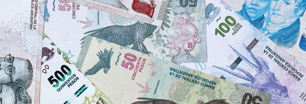 Argentine peso money banknotes bunch on table. Argentina bills of ARS currency close up